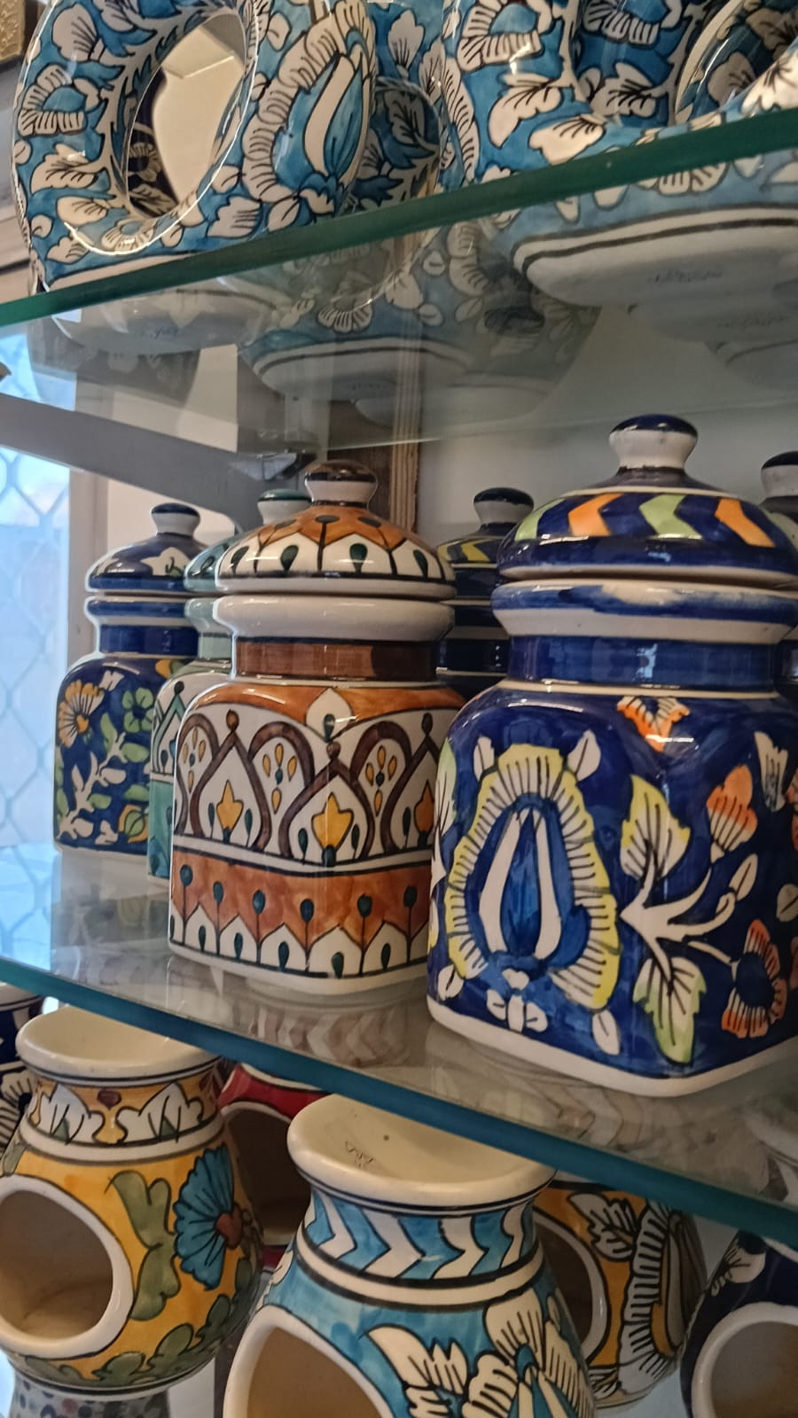 Handcrafted glazed ceramic storage jar with decorative lid